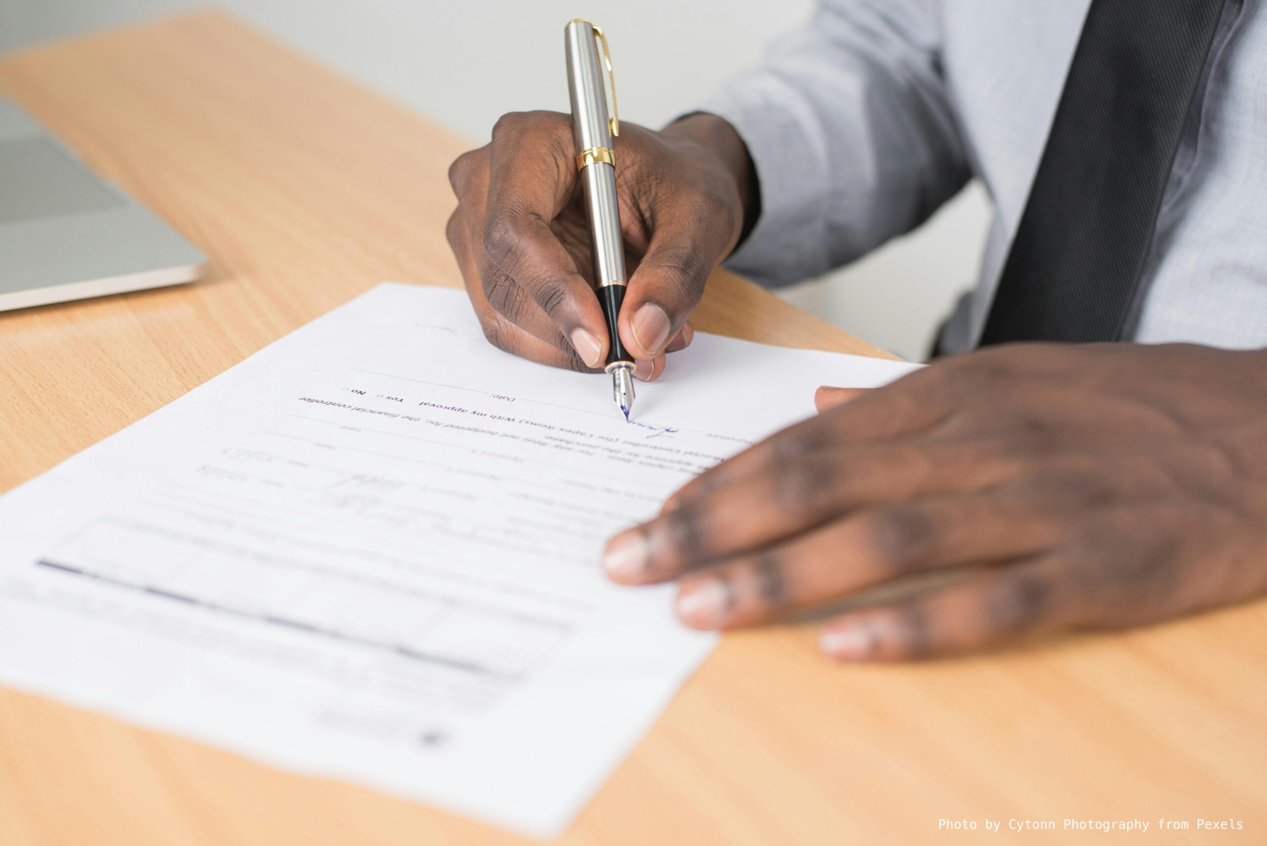 Photo by Cytonn Photography from Pexels: https://www.pexels.com/photo/person-holding-gray-twist-pen-and-white-printer-paper-on-brown-wooden-table-955389/